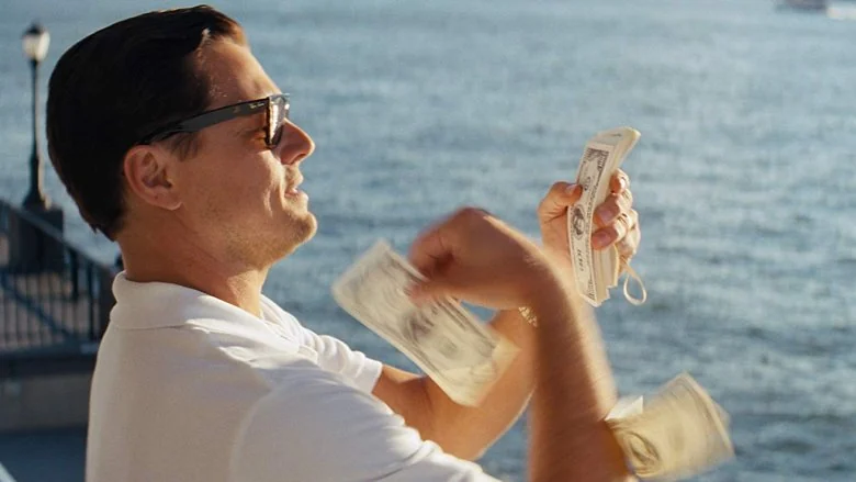 Man tossing money by the water